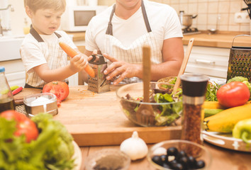 Father is cooking with his son