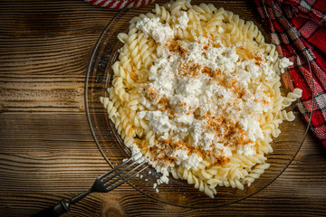 Fusilli pasta with cottage cheese, sugar and cinnamon.