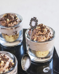 Delicious dessert with ice cream, chocolate mousse and cookies on the table, on a marble Board.