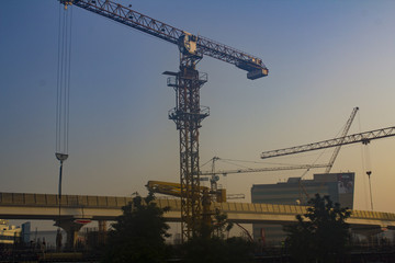 Construction site with cranes at dawn