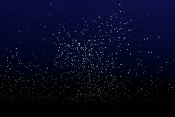 defocused golden defocused glitter on a blue background