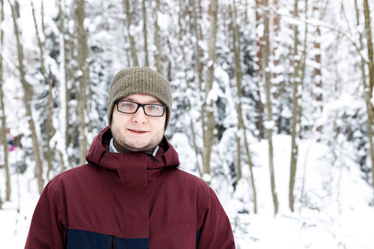 Sport style man portrait in the winter forest. Snow adventure