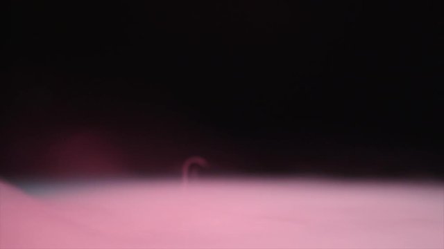 Pink smoke on black background
