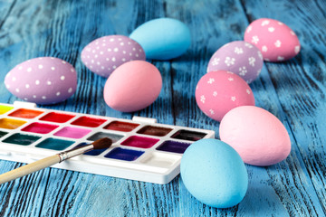 colorful easter eggs painted on wooden table