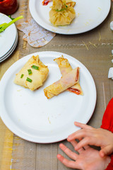 children stuff and decorate pancakes with jam and powder their own hands