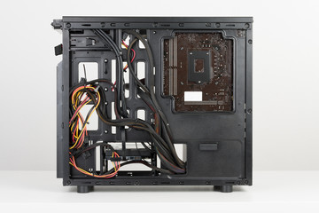 Building of PC, ATX motherboard and power supply unit inserted to tower case