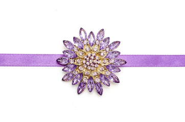 round brooch flower isolated on silk ribbon