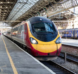 ready to depart, a highspeed train is a bout to depart the station