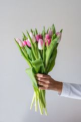 Bouquet of tulips in beautiful woman's hands.