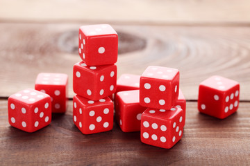Red dice on brown wooden table
