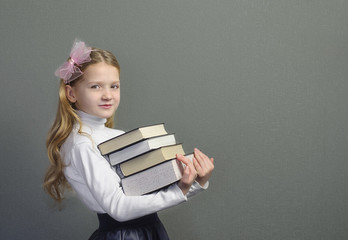 Pretty schoolgirl holding a book