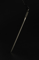 needle and thread macro isolated on black