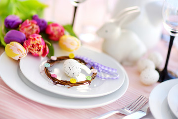 Beautiful table setting with crockery and flowers for Easter celebration