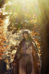 Virgin Mary statue. Vintage sculpture of sad woman in grief (Religion, faith, suffering, love concept)