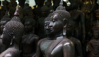 Big Buddha statues in the local Thai market. Antique Buddha statues close-up 