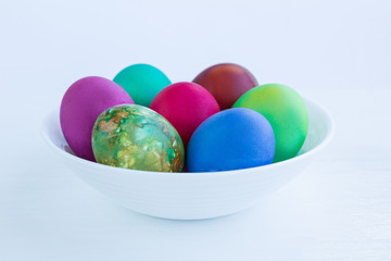 White Easter plate with multicolored boiled eggs decoration