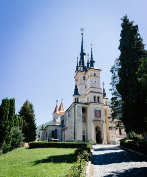 Sf. Nicolae (St. Nicholas) Orthodox Church exterior., Brasov, Transylvania, Romania. Famous tourist attraction travel destination vertical postcard.
