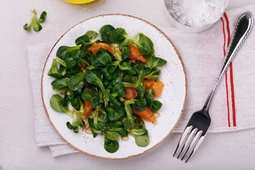 Dietary lunch: gentle salad Korn with pine nuts and tangerine. Dish for vegetarians, top view