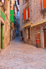 Fototapeta na wymiar Calm, peaceful little tight narrow streets and colorful houses of Rovinj town