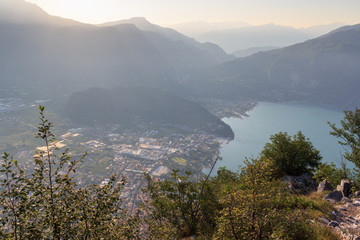 Obraz premium Riva del Garda town panorama at Lake Garda and mountains at sunrise in the morning, Italy