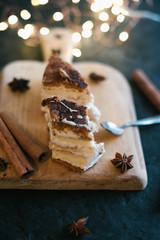 Cake on a wooden tray on a black matte background