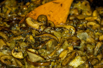 fried with onions and spices Royal mushrooms champignons in a frying pan