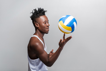 athletic African-American man with volleyball