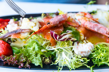 Assorted seafood: crab, prawns, langoustines are on the lettuce.