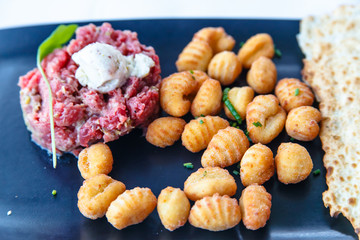 Steak Tartar of raw beef with potato croquettes.