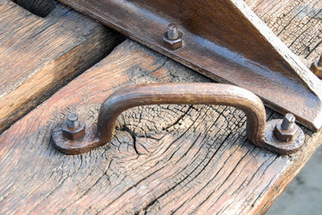 An iron handle on a wooden board