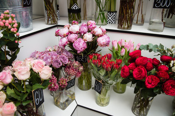 Flower bouquets in vases at store indoors