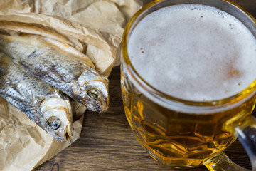 Traditional Russian snacks to beer. Dried roach on paper.
