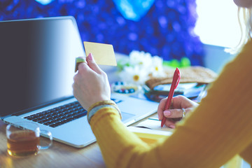 Young woman on a coffee break or enjoying the coffee-break, Using laptop computer