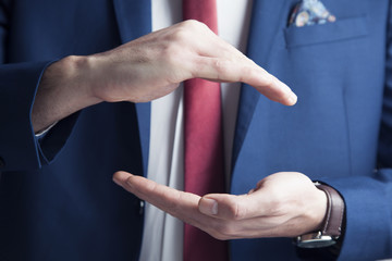 male is standing and shows outstretched hand with open palm