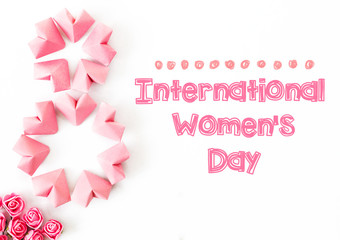 Fototapeta na wymiar Happy International Women’s Day celebrate on March 8, congratulatory CARD. rose-color paper hearts shape figure eight 8 on white background 