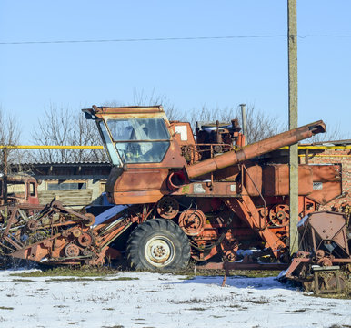 Rusty old combine harvester. Garage of agricultural machinery.