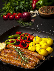 Wiener Sausages in a pan on black background