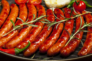 Wiener Sausages in a pan on black background