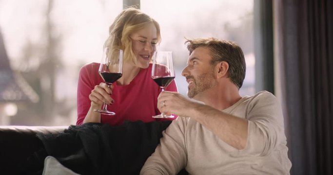 Attractive Couple enjoying a glass of Wine at home