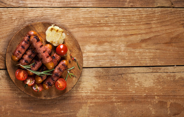 Festive cocktail sausages wrapped in crispy smoked bacon commonly known as 'Pigs in Blankets' on wooden background
