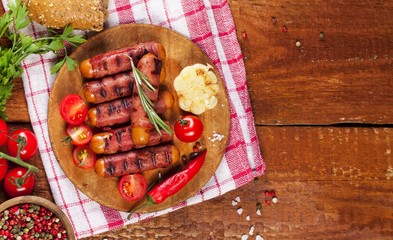 Festive cocktail sausages wrapped in crispy smoked bacon commonly known as 'Pigs in Blankets' on wooden background