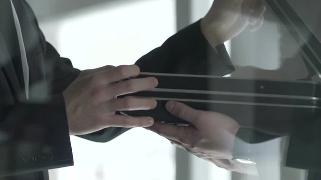 Politician checking dollar bills cash in open briefcase, bribe money offering