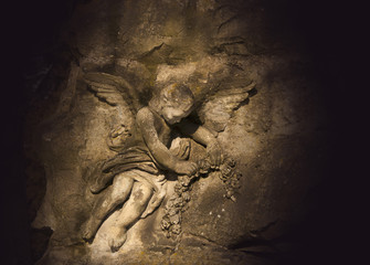 Аngel carved out of a large stone boulder (religion, Christianity, faith concept)