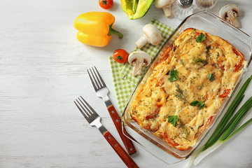 Glass baking dish with delicious casserole on table, top view. Fresh from oven