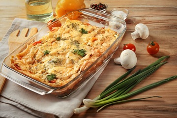 Glass baking dish with delicious casserole on table. Fresh from oven