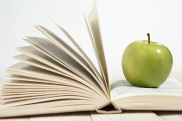 Stack of books and apple on the table. Copy space for text. Selective focus. Knowledge concept