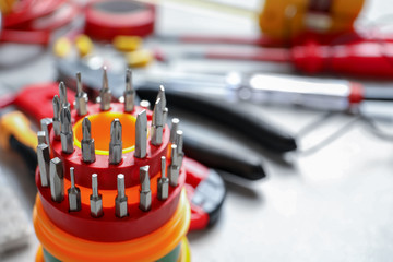 Fototapeta premium Screwdriver bit set and blurred electrical tools on background