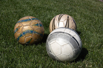 Fototapeta na wymiar Soccer balls lying in the grass