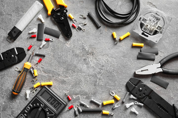 Different electrical tools on grey background