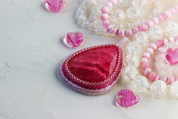 Pink quartz, glass beads for making necklaces. Needlework.